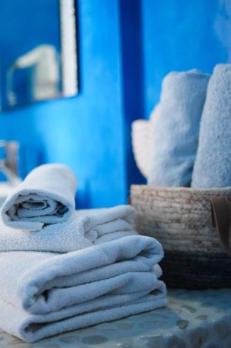 a pile of towels sitting on top of a table at Roula Villa Studios & Apartments in Perissa
