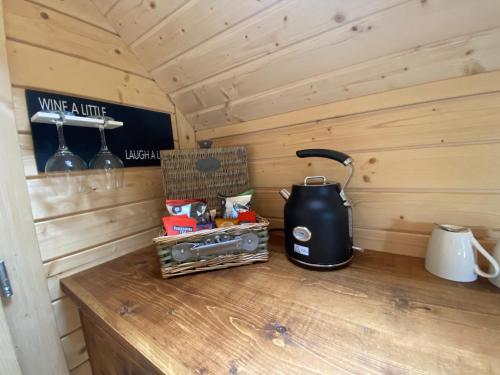 a room with a stove and a kettle on a counter at Press Brook Park in Clay Cross