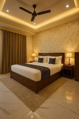 a bedroom with a large bed with two night stands and two lamps at Hotel Krishna Palace, Vrindavan - Lavish & Luxury rooms with parking near prem mandir #By Om # in Vrindāvan