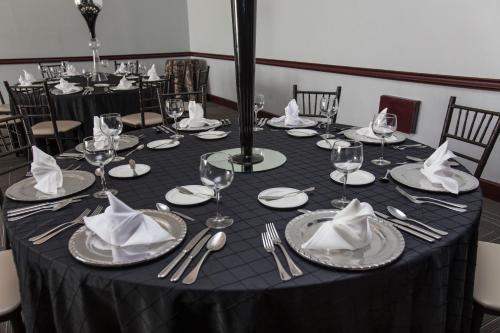a table with a black table cloth and silverware on it at Novotel Monterrey Valle in Monterrey