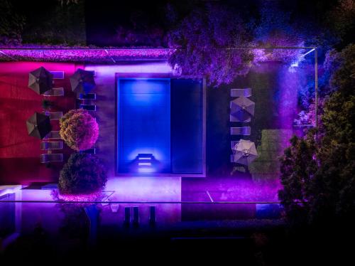 a house with a blue screen and purple lights at goldfinger + suites in Lana
