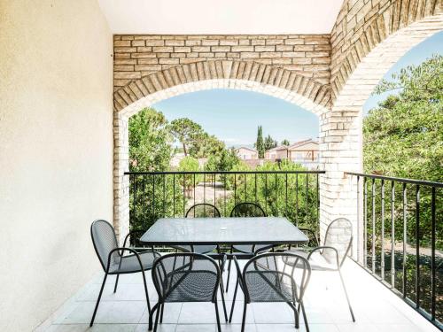 a patio with a table and chairs on a balcony at Zaton Holiday Resort in Nin
