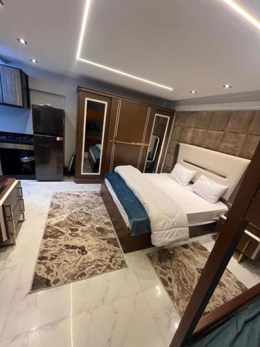 a bedroom with a large bed and a television at Happy apartment 3 in Cairo