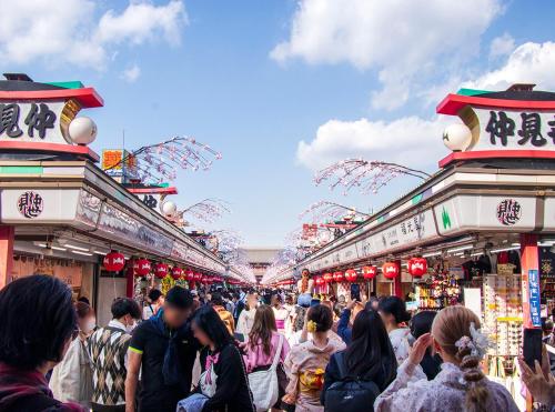 a crowd of people walking through a crowded market at Hotel Trend Asakusa in Tokyo