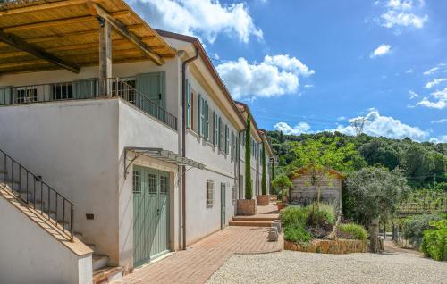 an exterior view of a house with a green door at Gorgeous Home In Strettoia in Strettoia