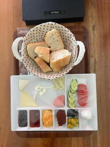 a basket filled with bread and different types of food at Joi Suites Hotel in Istanbul