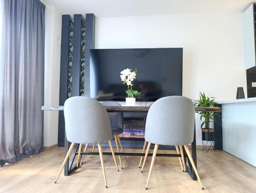 a dining room with a table and two chairs at Connected in Brčko