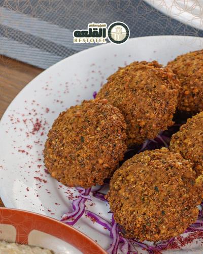 a white plate with some food on it at Alqalah Restotel فندق ومطعم القلعة in Kerak
