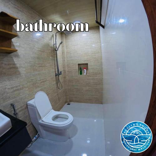 a bathroom with a white toilet and a shower at All Inclusive Stays by Excited Tours - Dhiffushi in Dhiffushi