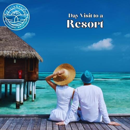 a man and a woman sitting on a dock in the ocean at All Inclusive Stays by Excited Tours - Dhiffushi in Dhiffushi