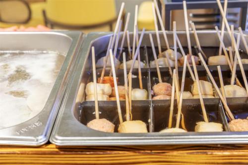 a tray of food with chop sticks in it at Best Western Ratchada Hotel in Bangkok