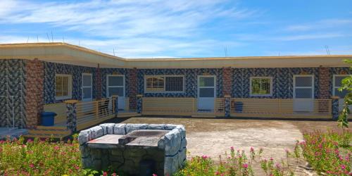 a building with a stone bench in front of it at Michael's Homestay - Farm Villa near Patar Beach & Bolinao Falls in Bolinao