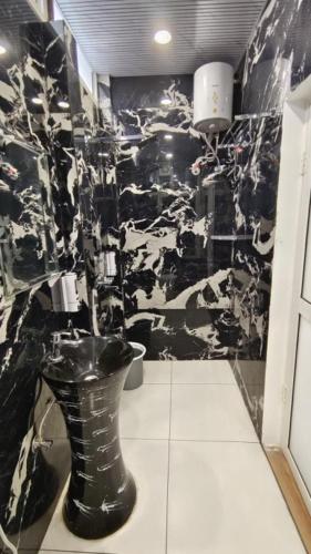 a black and white bathroom with a toilet at Joey's Hostel Jaipur in Jaipur