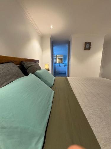 a bedroom with two beds and a door to a room at The Lux Dip in Perth