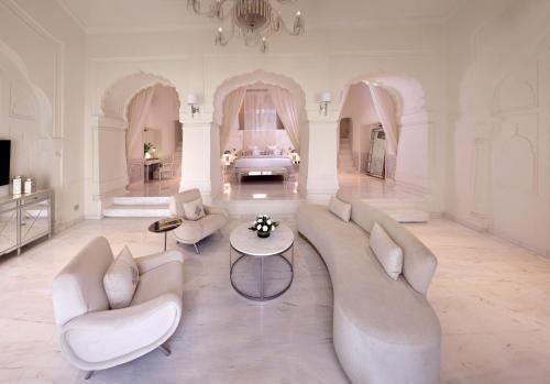 a large living room with white furniture and a bed at RAN BAAS The Palace An 18th-century Royal Palace in Punjab in Patiāla