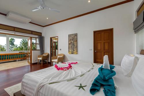 a bedroom with a bed with an elephant on it at Baan Angelo 3 Bed Private Pool Villa, Kata Hill in Ban Kata