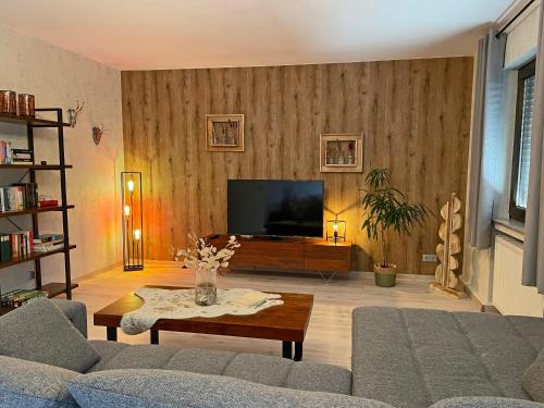 a living room with a couch and a flat screen tv at Ferienwohnung Preziosa in Idar-Oberstein