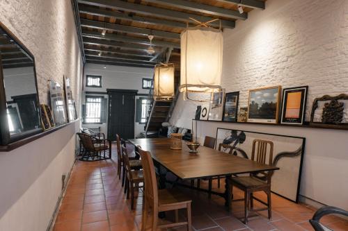 a dining room with a wooden table and chairs at Cheong Fatt Tze - The Blue Mansion in George Town