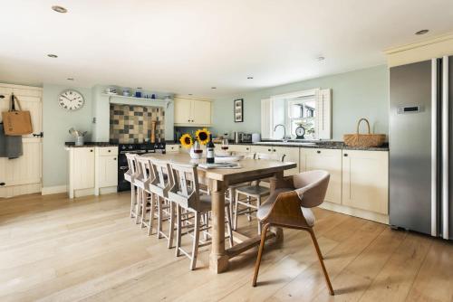 a kitchen with a large dining table and chairs at Glen Bank in Bampton