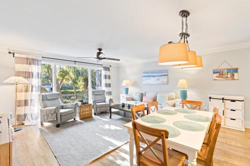 a dining room and living room with a table and chairs at Lagoon Villa 43 - Close to Ocean! Easy Access to Resort! in Isle of Palms