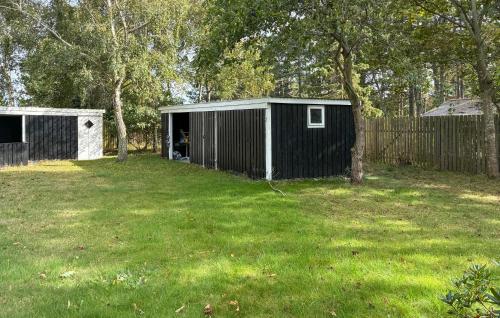 a black and white shed in a yard at 4 Bedroom Beautiful Home In Store Fuglede in Bjerge
