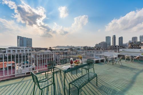 a balcony with a table and chairs on a roof at 尚品9号海景民宿Seaview Hotel in Xiamen