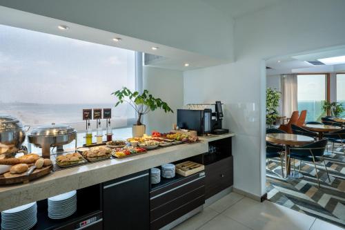 a buffet line with many different types of food at Carlton Tel Aviv Hotel – Luxury on the Beach in Tel Aviv