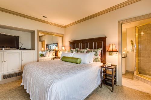 a bedroom with a large bed and a television at Hotel Bellwether on Bellingham Bay in Bellingham