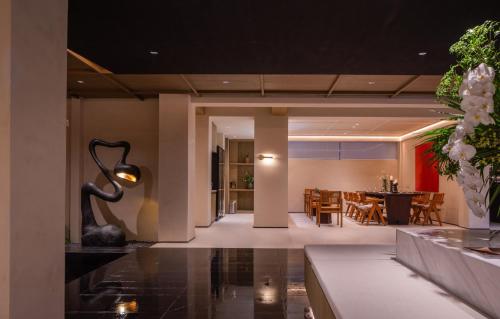 a living room with a table and a dining room at Da Li Yuan Lu Hotel in Dali Ancient Town