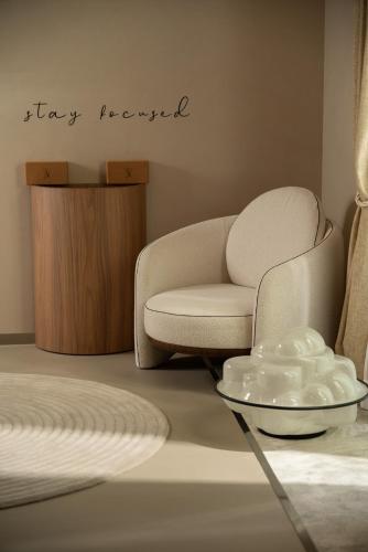 a living room with a chair and a table at Mode Eco Mood Hotel - Adults Friendly in Rimini