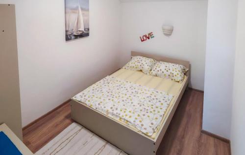 a small bed in a small room with at Awesome Apartment In Tkon With House Sea View in Tkon