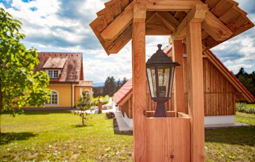 a wooden lantern in a yard with a house at Privates Chalet Mit Pool in Stainz