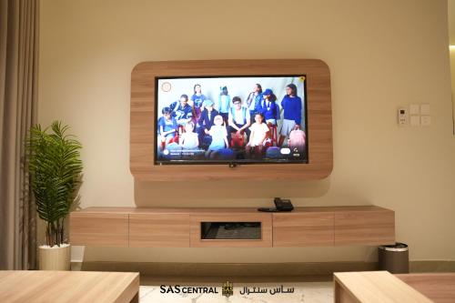 a television with a group of people on the screen at SAS Central in Salalah