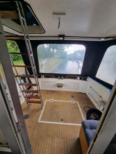 a view of the inside of a boat with a ladder at Gezellig overnachten, Luxe boot in Zuidlaren