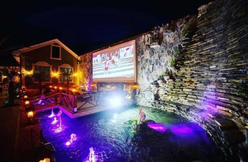 a pool of water in front of a building at night at Museum Boutique Luxury GH in Sheki