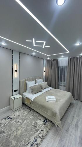 a bedroom with a large bed in a room at Люкс квартиры in Taraz