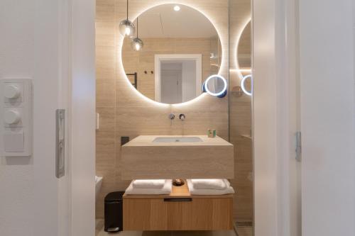 a bathroom with a sink and a mirror at Six Residences Prague in Prague