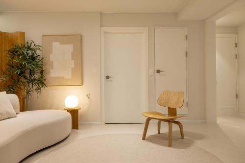 a bedroom with a bed and a chair at Harangae in Seoul