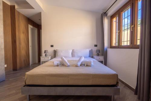 a bedroom with a bed with two pillows on it at Il Piccolo Borghetto in Rome