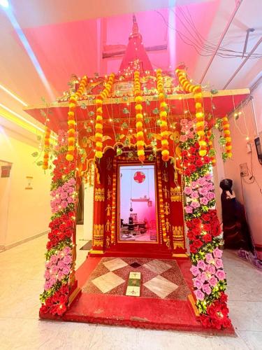 a large altar with flowers in a room at Hotel shiva international in Varanasi