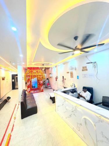 a man sitting at a bar in a room at Hotel shiva international in Varanasi