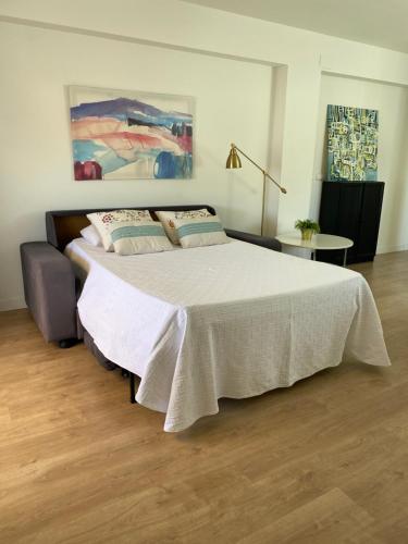 a bedroom with a bed with a white blanket at Penthouse Asuncion Feria in Seville