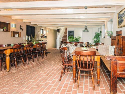 a dining room with wooden tables and chairs at Kaløvig Beach Holiday Centre in Rønde