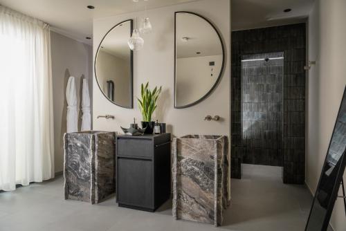 a bathroom with a shower and a sink and mirrors at Mode Eco Mood Hotel - Adults Friendly in Rimini