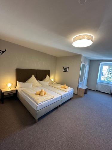 a bedroom with a large bed and a large window at AltstadtQuartier in Schwedt