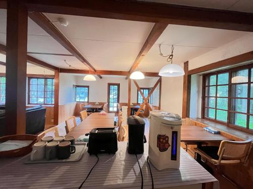 a large room with a long wooden table and chairs at 白馬蔵雲Zone in Hakuba