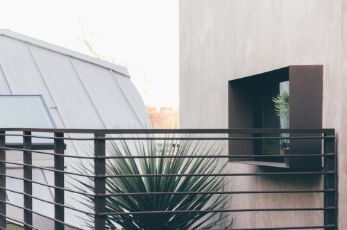 a potted plant on a balcony of a building at Heywood Hotel in Austin