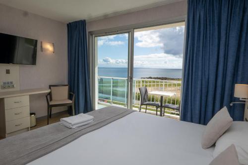 a hotel room with a bed and a view of the ocean at Hotel Europa in Quiberon