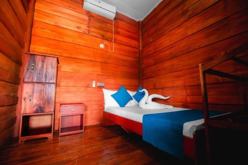 a bedroom with a bed in a wooden room at KAYJAY WILD WILPATTU in Wilpattu
