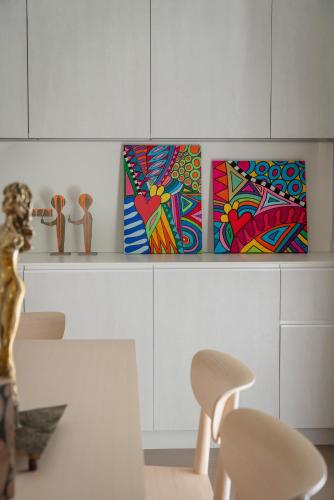 a dining room with two paintings on a shelf at Mode Eco Mood Hotel - Adults Friendly in Rimini